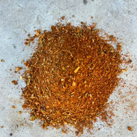 A pile of brown and red spice blend.