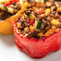 Stuffed red bell pepper with meat and vegetables.