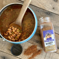 Spicy beans in pot with seasoning.