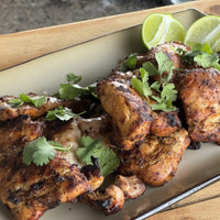 Grilled chicken thighs with lime and cilantro.