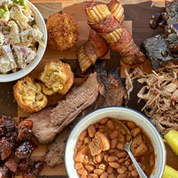 BBQ platter with sides and pickles.