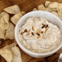 White dip with chips on wooden board.