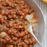 Chili with beans in a metal bowl.
