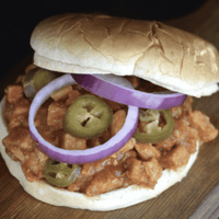 Sloppy joe sandwich with onions and jalapenos.
