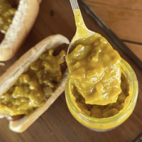 Hot dogs topped with yellow mustard relish.
