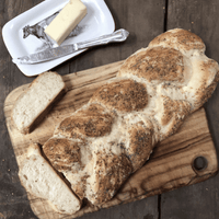 Braided loaf of bread with poppy seeds.