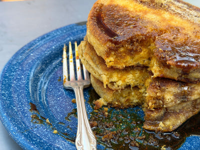 Johnny Cakes on a blue plate, drizzled with molasses.