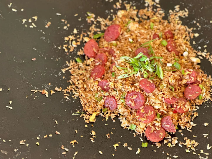A pile of rice and meat on top of a table.
