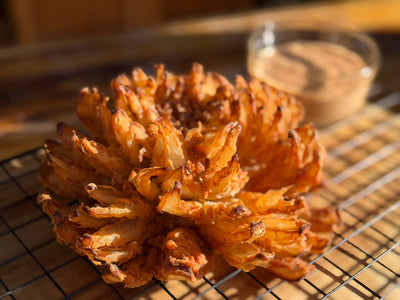 A blooming onion on a wire rack 