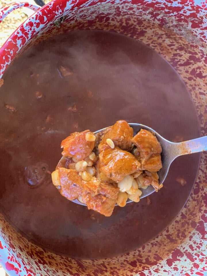 Spoonful of meat and beans stew.