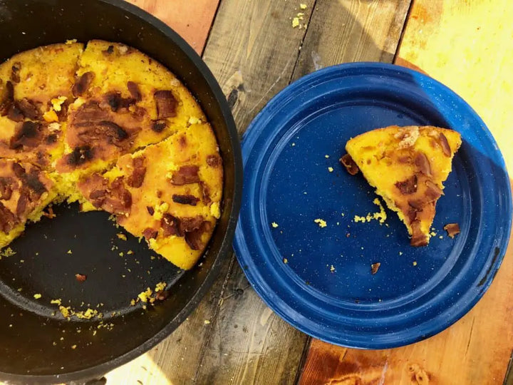 A plate of cornbread with bacon bits.