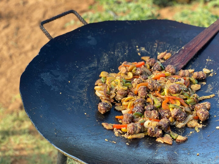 Meatballs and vegetables cooking in a pan.