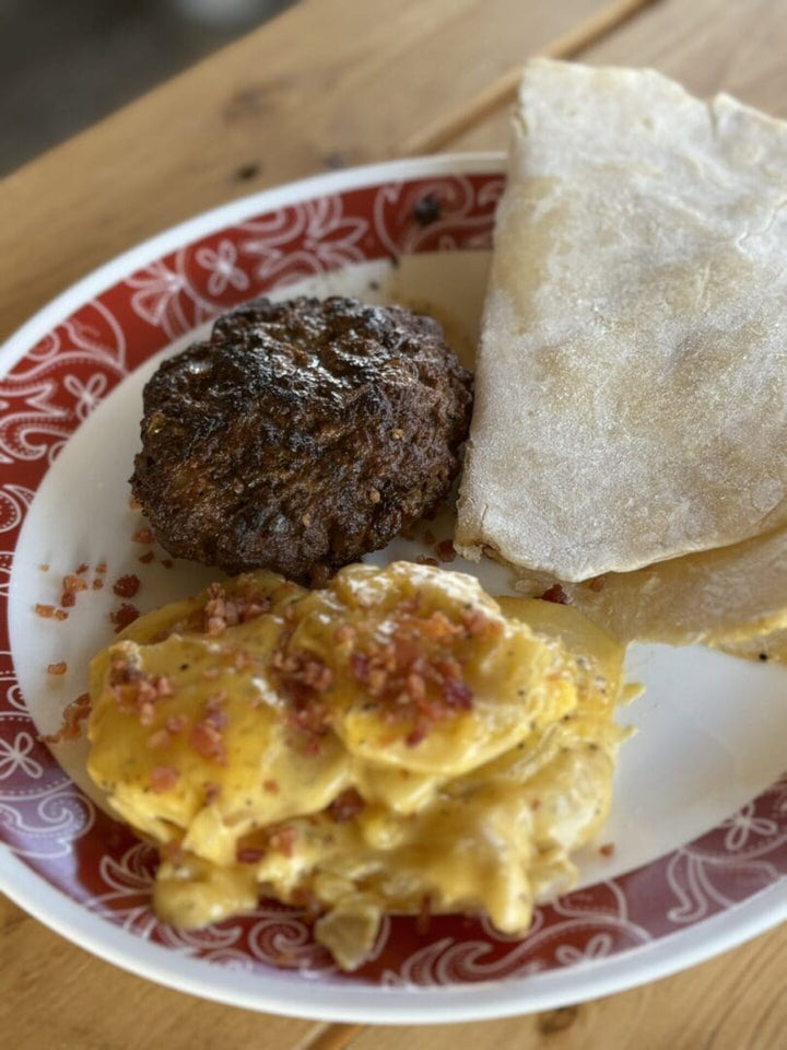 Burger, potatoes, and flatbread on plate.