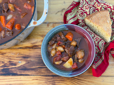 Beef stew with tender beef, red potatoes, carrots, and pearl onions in a rich broth.