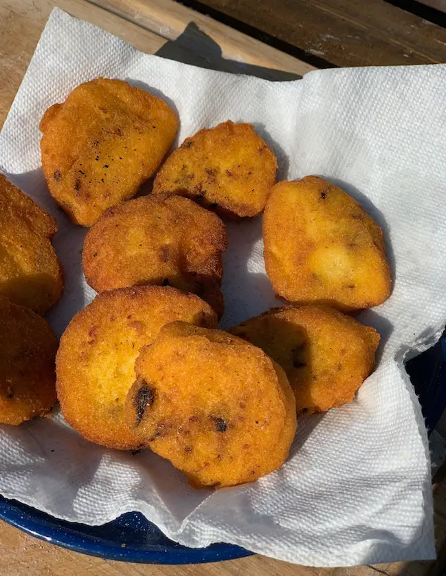 Fried cornbread on a paper towel.