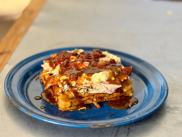 A leftover thanksgiving turkey slider on a blue plate
