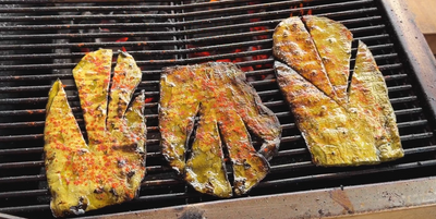 Three Nopales pads on a live fire grill 