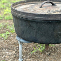 Cast iron pot on a tripod stand.