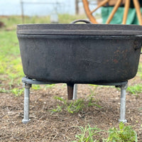 Black cast iron pot on a stand.