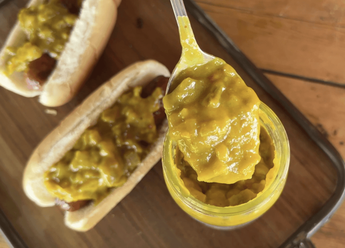 Hot dogs topped with yellow mustard relish.