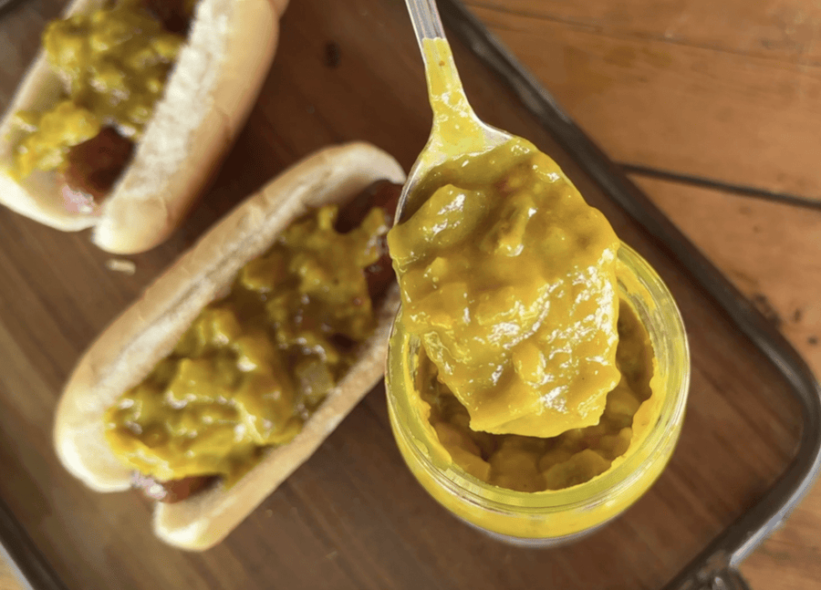Hot dogs topped with yellow mustard relish.