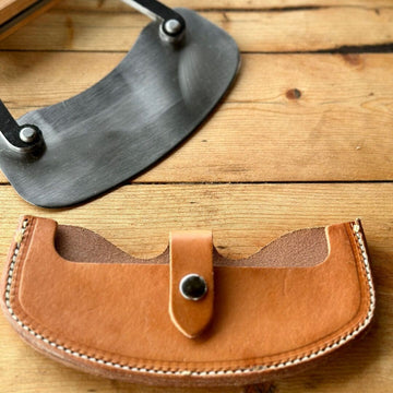 Leather sheath for a cheese knife.