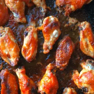 Close-up of baked chicken wings in a pan.