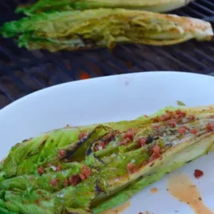 Grilled romaine lettuce with bacon dressing.