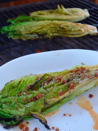 Grilled romaine lettuce with bacon dressing.