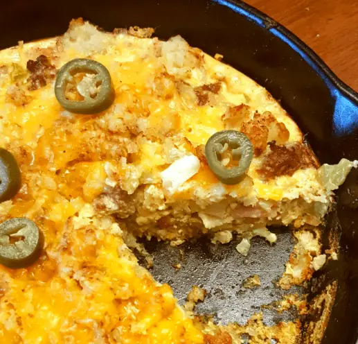 Cheesy breakfast casserole with jalapenos in a skillet.