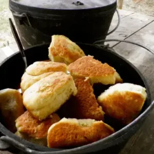 A pan of food sitting on top of the ground.