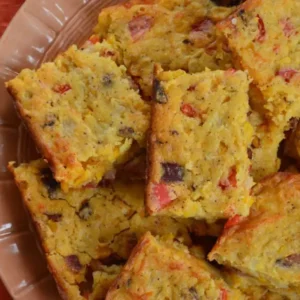 Cornbread squares on a brown plate.