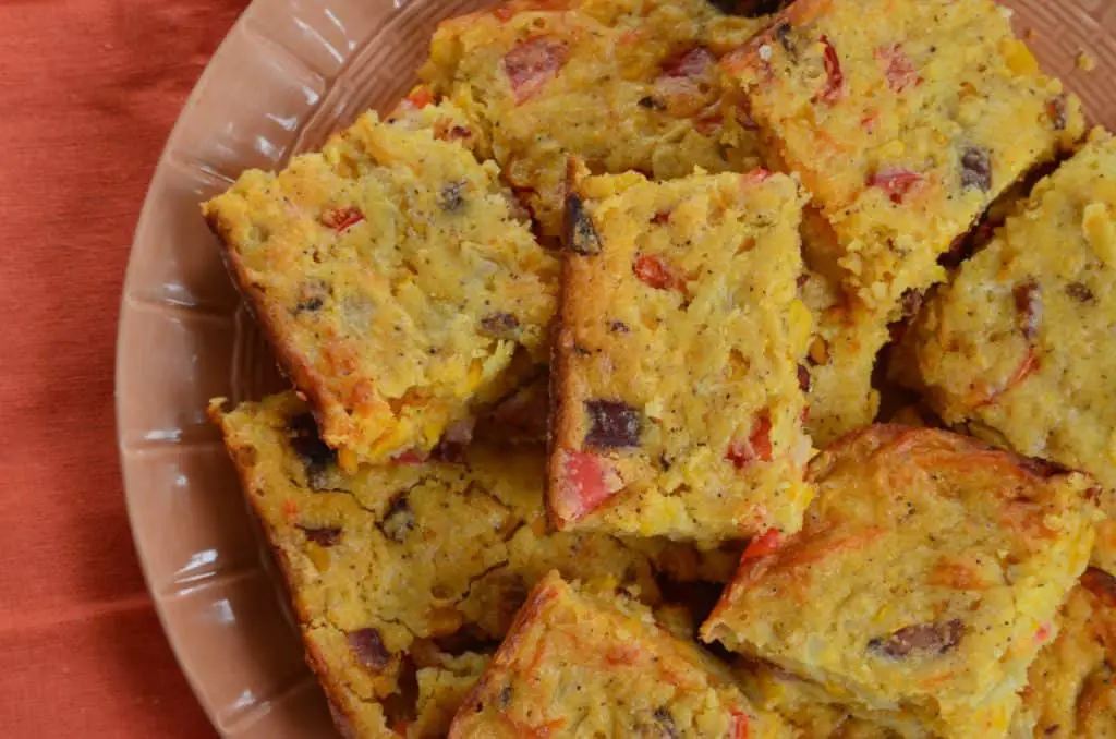 Cornbread squares on a brown plate.