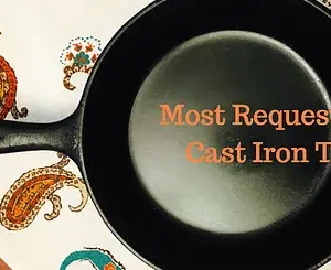 Black cast iron skillet on a patterned cloth.