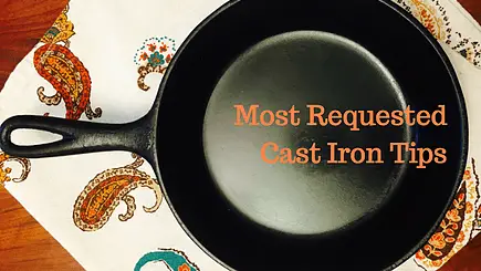 Black cast iron skillet on a patterned cloth.