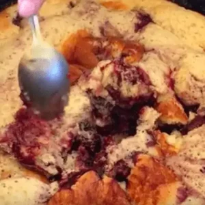 Close up of blackberry cobbler with spoon