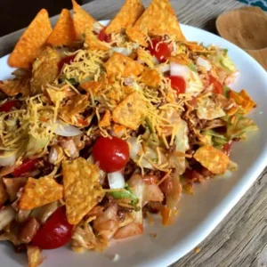 Taco salad with cheese and chips.