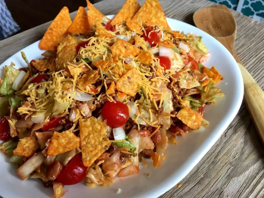 Taco salad with cheese and chips.