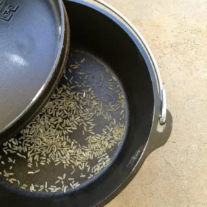 Uncooked rice in a cast iron pot.