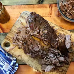 Shredded beef on a cutting board.