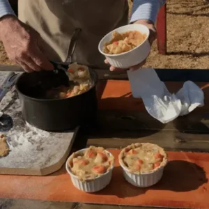 Chicken pot pie being prepared on table.