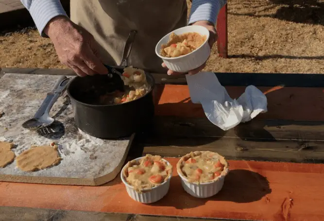 Chicken pot pie being prepared on table.