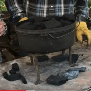 Black cast iron pot on a tripod stand.