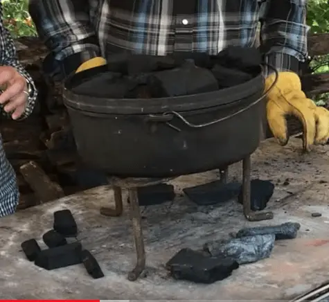 Black cast iron pot on a tripod stand.