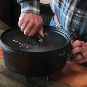 A person using a cast iron pot.