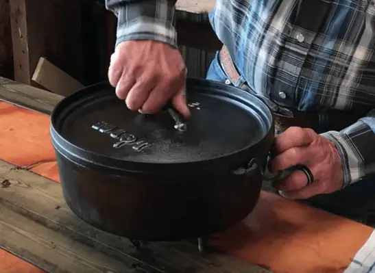 A person using a cast iron pot.