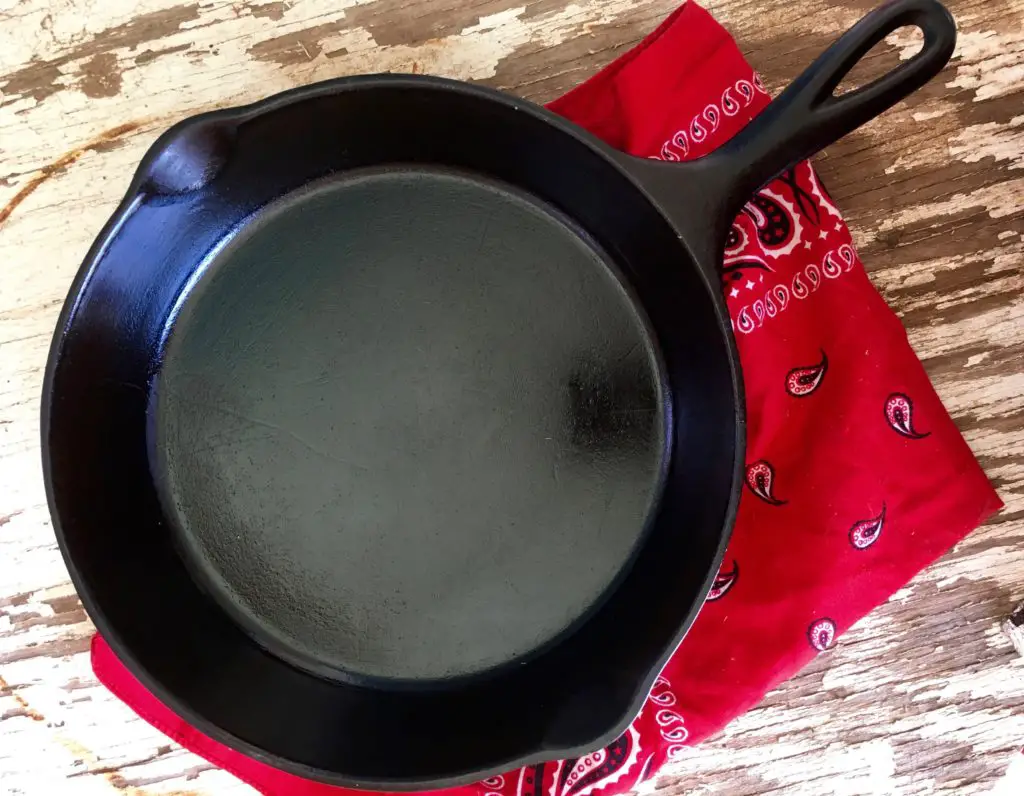 Black cast iron skillet on red bandana.