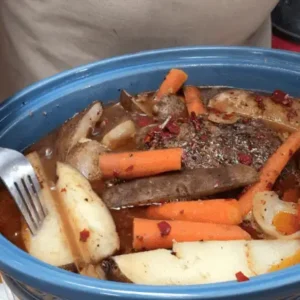 Roast in a slow cooker with potatoes and carrots.