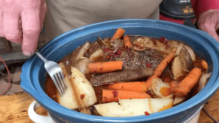 Roast in a slow cooker with potatoes and carrots.