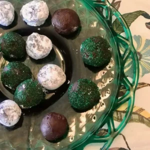 Chocolate and peppermint truffles on a green plate.